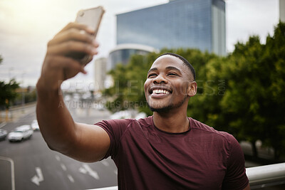 Buy stock photo Selfie, black man and in city with smile, on vacation and cheerful for break, casual and relax. African American male, guy and smartphone for social media, connection and in town for chill or weekend