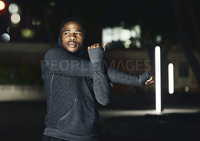 Buy stock photo Fitness, stretching and black man in city at night do warm up for running, workout and marathon training. Sports, commitment and male stretch arms for health, motivation and ready to start exercise