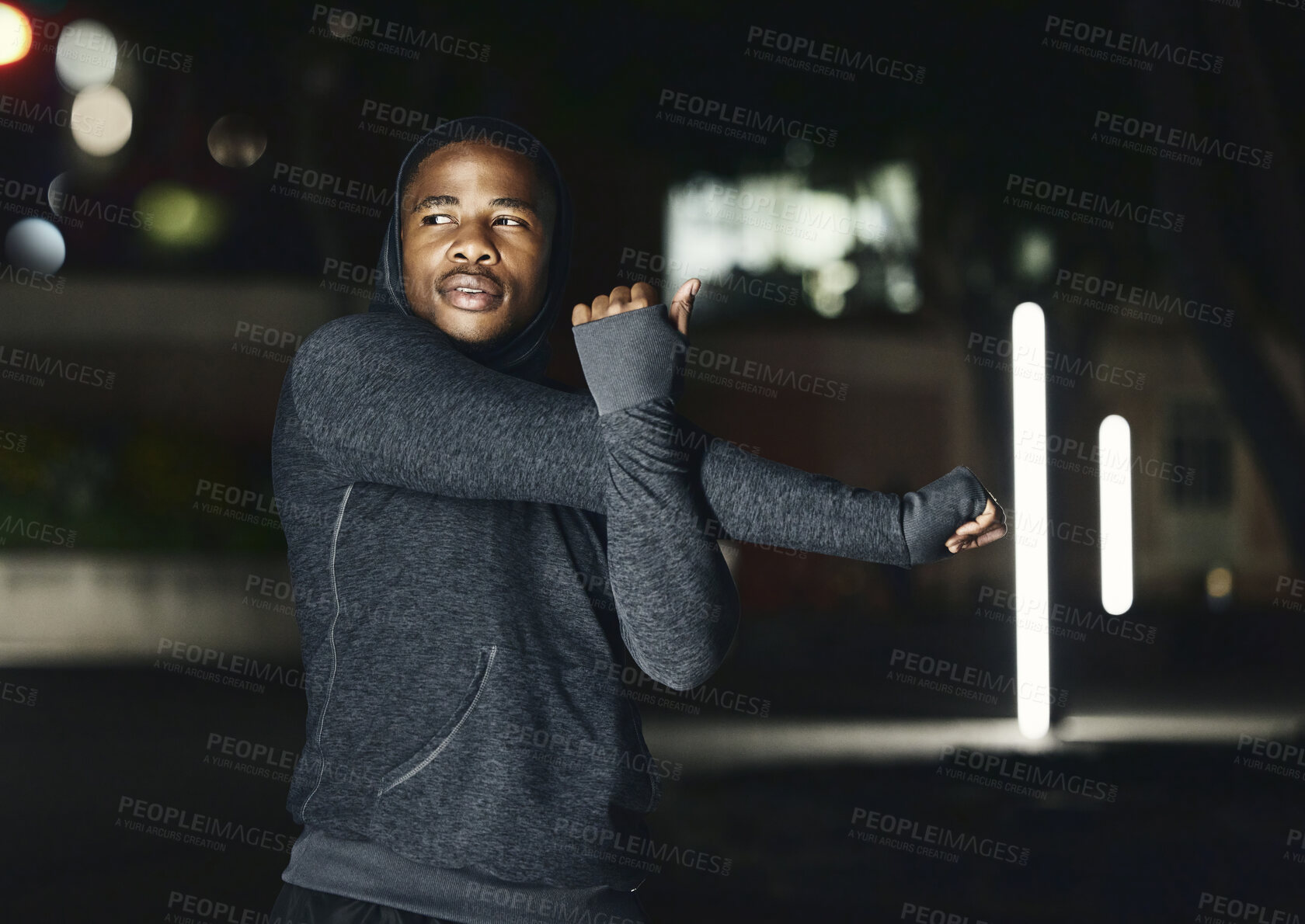 Buy stock photo Fitness, stretching and black man in city at night do warm up for running, workout and marathon training. Sports, commitment and male stretch arms for health, motivation and ready to start exercise