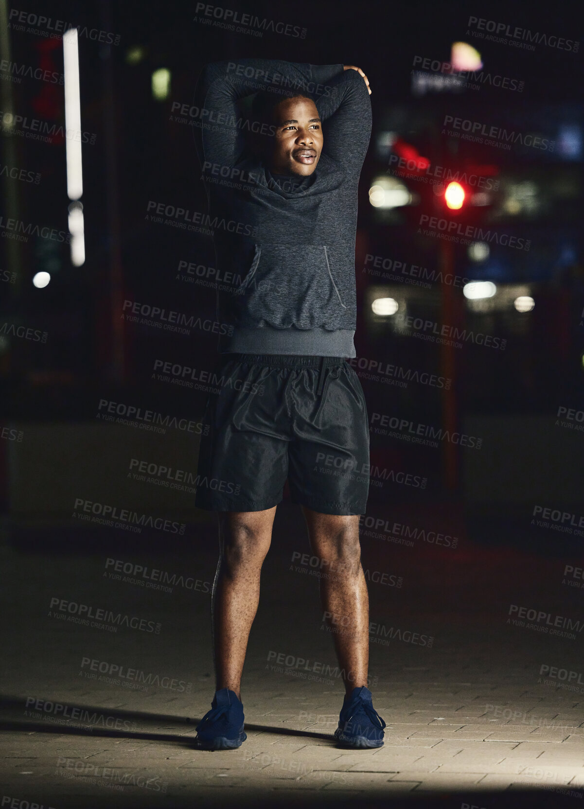 Buy stock photo Black man, outdoor and stretching at night, fitness and exercise for health, body care and balance. African American male, evening or dark in city, workout and training for healthcare, power or relax