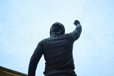 Buy stock photo Success, fitness and man with fist on outdoor, blue sky mockup for workout goals, energy and winning in sports race competition. Rear of athlete with mock up for marketing of winner, power hand sign