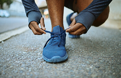 Fitness, hands and shoes on man in a road for lace tie, exercise and running in a city, closeup and cardio. Hand, feet and runner, athletic and male in a street before sports, running and workout