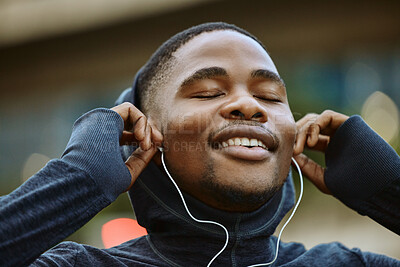 Buy stock photo Happy black man, exercise and listening to music while running outdoor with earphones for fitness motivation, health and wellness. Face of athlete happy while streaming audio during training workout
