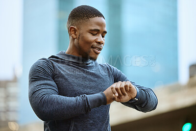 Buy stock photo Fitness, black man and checking time in the city ready for exercise, workout or cardio training in the outdoors. Active man in sports looking at smart watch for heart monitoring, rate or performance