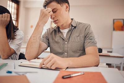 Buy stock photo Stress, headache and student in classroom with anxiety, mental health risk and burnout for study, education and learning problem. Tired, fatigue and depression of teenager in school or college desk