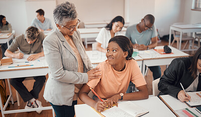 Buy stock photo Teacher, student and classroom for test, knowledge and learning for higher education. Young female, black woman or educator helping pupil in exams, talking or students writing notes in books or focus