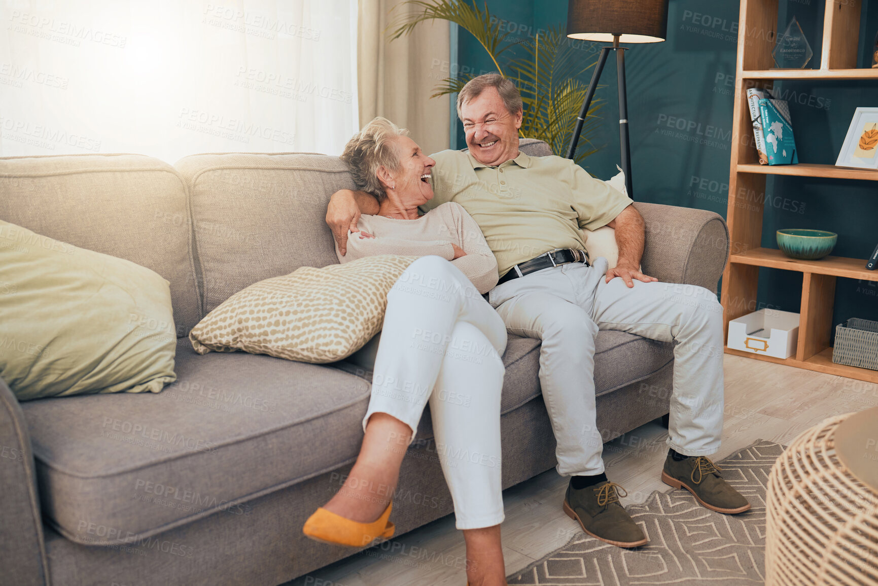 Buy stock photo Senior couple, bonding or laughing on sofa, house or home living room in trust, love or Canada security. Smile, happy or comic retirement elderly, man or woman on relax furniture in funny comedy joke