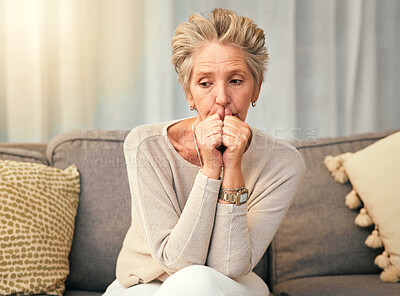 Buy stock photo Anxiety, depression and elderly woman on sofa thinking, worry and suffering memory loss in living room. Sad, confused and senior woman on couch afraid, phobia and suffer from alzheimers or dementia