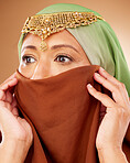 Muslim, skincare and woman with hijab in studio for beauty, wellness and cosmetic treatment on brown background. Islam, girl and model in face scarf relax with pamper, grooming and wellness in Dubai 