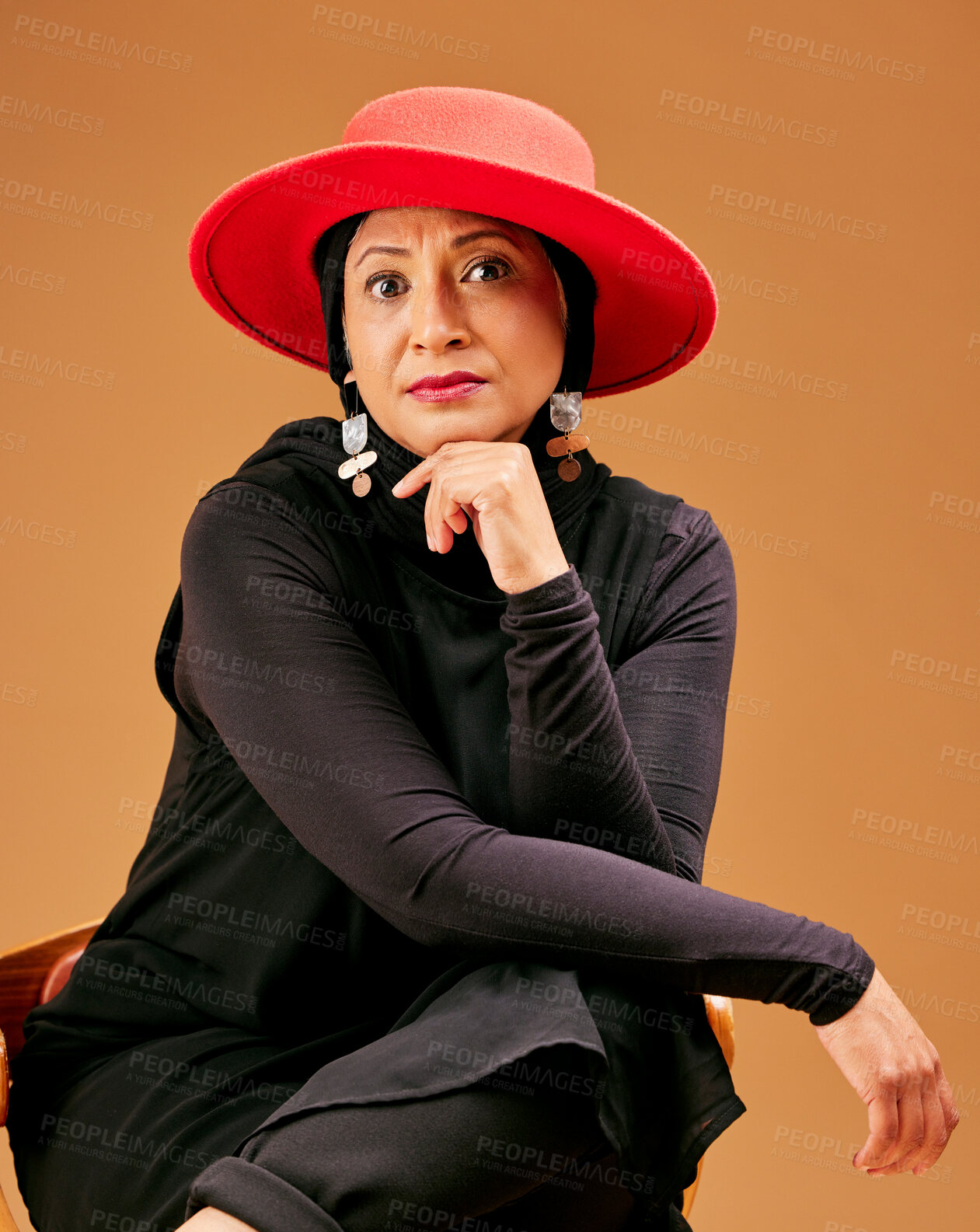 Buy stock photo Black woman, islamic fashion portrait and serious face for beauty, trendy designer wear and modern muslim. Senior woman, trendy arabic lifestyle and culture or religion in brown studio background 