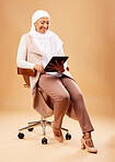 Happy woman, muslim and tablet technology on studio chair for website, social media and online internet app. Mature Indonesian lady, islamic hijab and entrepreneur search digital marketing connection