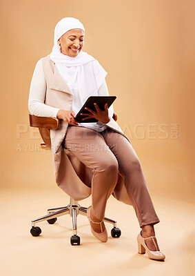 Buy stock photo Happy woman, muslim and tablet technology on studio chair for website, social media and online internet app. Mature Indonesian lady, islamic hijab and entrepreneur search digital marketing connection