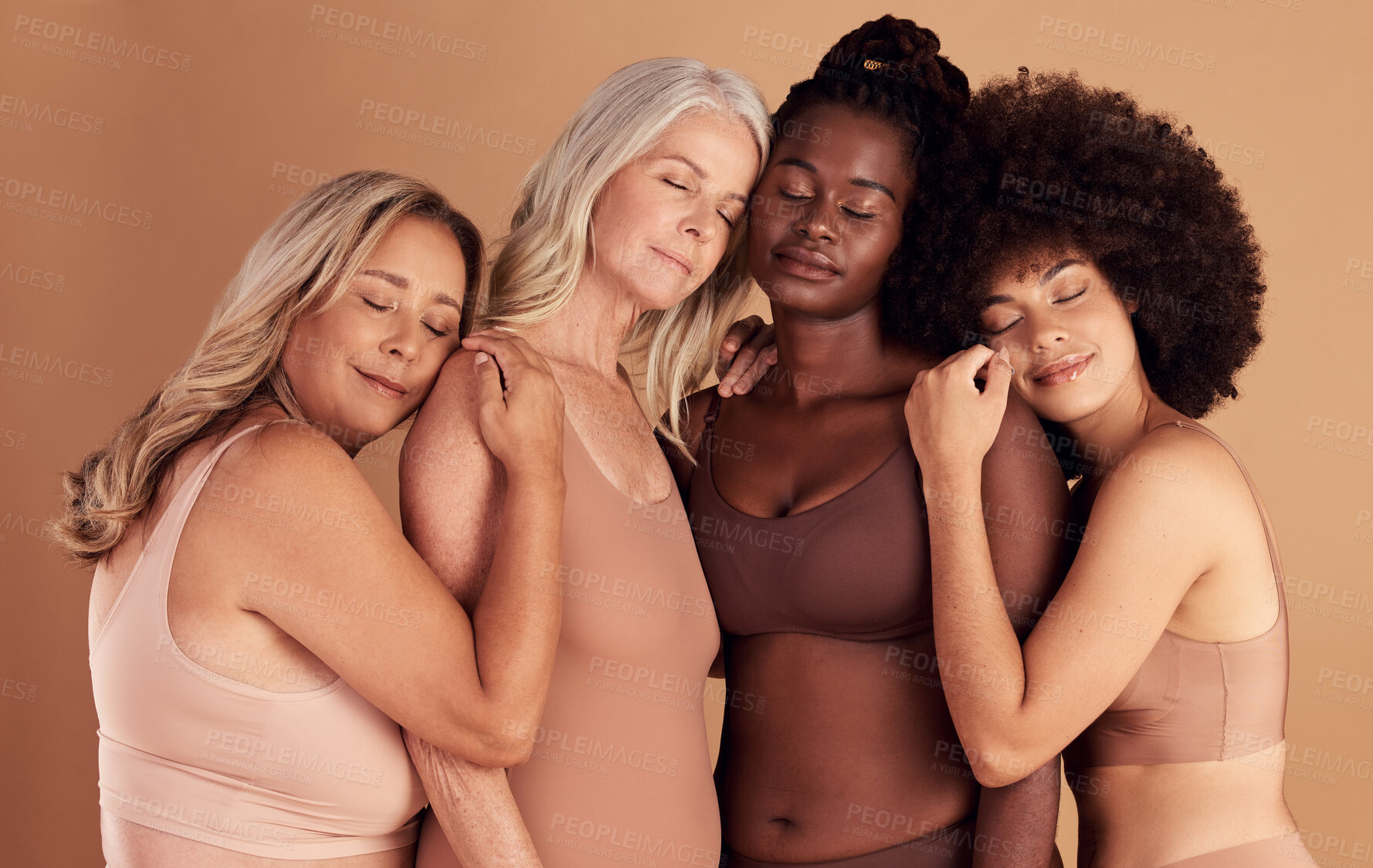 Buy stock photo Support, diversity and women with hug for body positive marketing, solidarity and advertising underwear on a studio background. Collaboration, affection and model friends hugging for empowerment