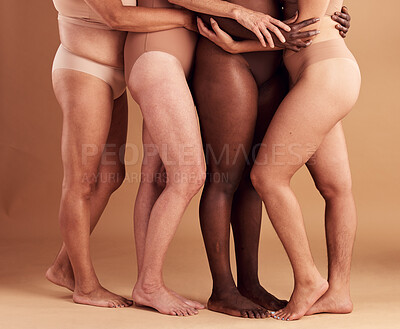Buy stock photo Diversity, legs and body positivity, women in underwear huddle together on studio background. Feet, friends and health, empowerment in self love and care in global community of diverse female bodies.