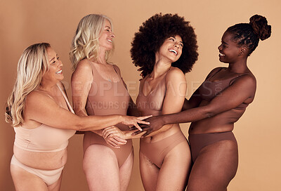 Buy stock photo Support, love and diversity of women in underwear, beauty collaboration and smile for body positivity against brown studio background. Community, care and model people with solidarity and confidence