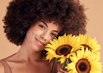 Buy stock photo Skincare, natural and black woman portrait with sunflower bouquet for afro hair care, beauty and cosmetic campaign. Smile of beautiful model with healthy skin and hair texture in beige studio.