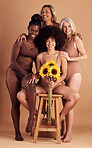 Plus size women, lingerie and group portrait with sunflower for beauty, wellness and solidarity in studio. Model team, underwear and flowers with support hug, diversity and smile by studio backdrop
