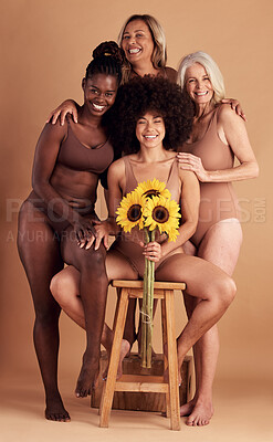 Buy stock photo Plus size women, lingerie and group portrait with sunflower for beauty, wellness and solidarity in studio. Model team, underwear and flowers with support hug, diversity and smile by studio backdrop