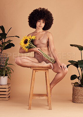 Buy stock photo Self love, flowers and black woman in underwear for body positivity, beauty empowerment and body shape on a studio background. Creative, sunflower and portrait of a model with confidence in her skin