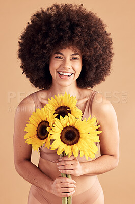 Beauty, skincare and black woman with sunflower, smile and natural hair on a studio background for cosmetics, makeup and self love. Portrait afro female with flowers for spring dermatology and glow