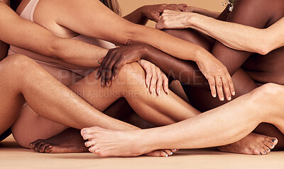 Buy stock photo Legs, skincare and diversity of body positive women, natural beauty and wellness in studio. Group, models sitting together in underwear for wellness, global community and empowerment for self love 