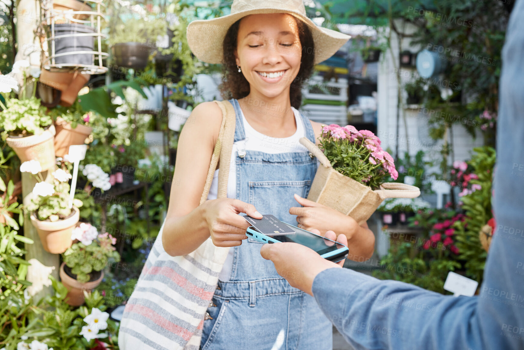 Buy stock photo Payment, flower shopping and woman at a nursery, credit card tapping and machine for ecology at a small business. Paying, bouquet and girl buying flowers with a debit card at a shop for agriculture