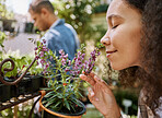 Smelling, plants and face of a woman at a nursery, flower shopping and aroma at a garden market. Happy, peace and girl with smell of flowers, pot plant and floral heather ecology at a gardening shop