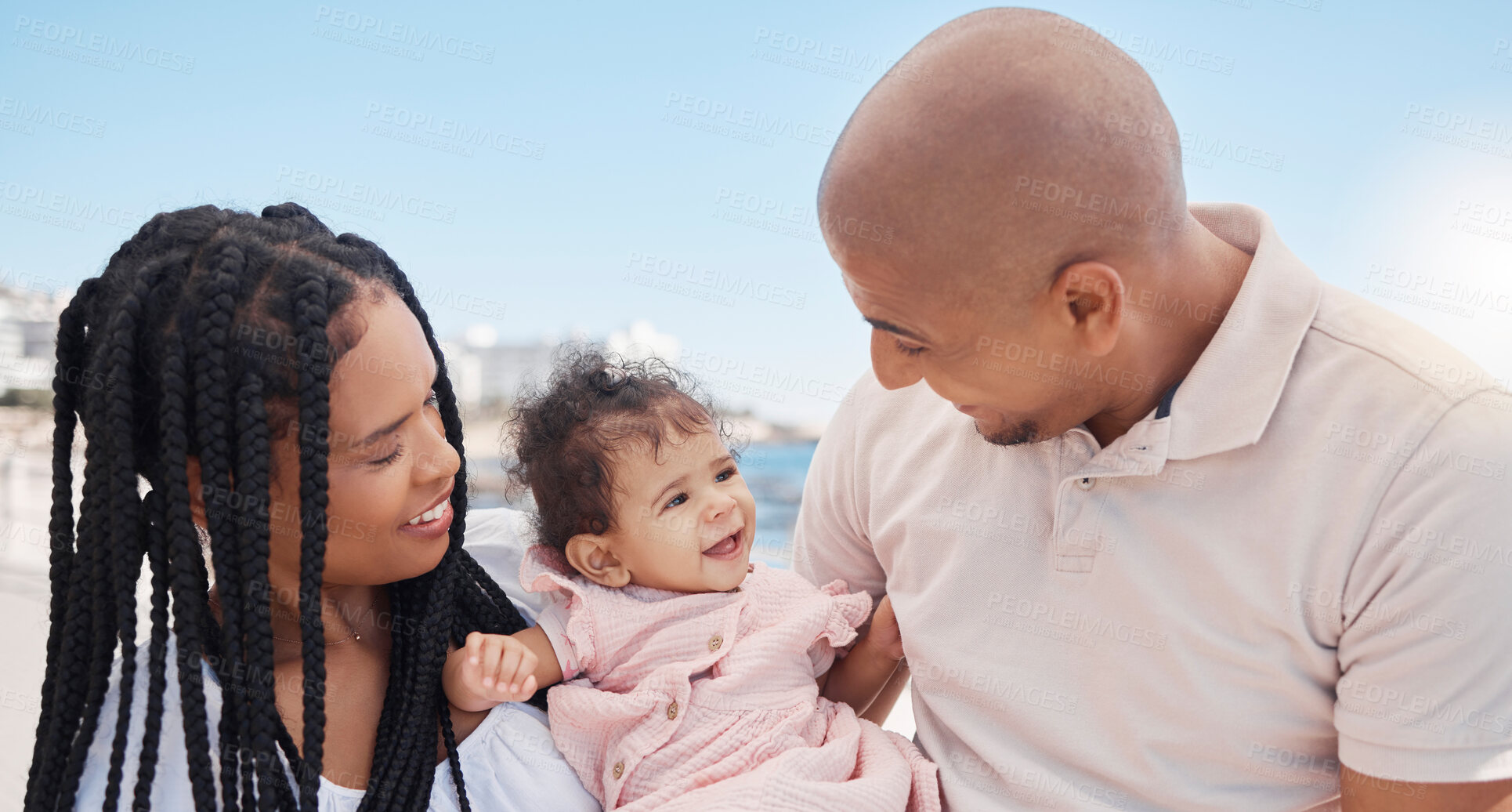 Buy stock photo Family, beach and bonding with a baby girl in nature with love, care and affection on a carefree holiday. Parents, mother and father with child by the sea for loving, caring bond with daughter