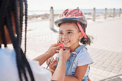 Buy stock photo Mother, child and helmet for bicycle, park and help with love, bonding and happiness by ocean in summer. Black woman, child and bike safety for learning, cycling and happy by ocean on family vacation