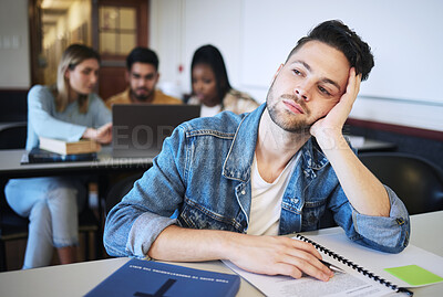 Buy stock photo Education, university and bored student in classroom thinking studying for exam. Sad young man at college, boredom and stress, depression or anxiety with book and academic students at desk on campus.