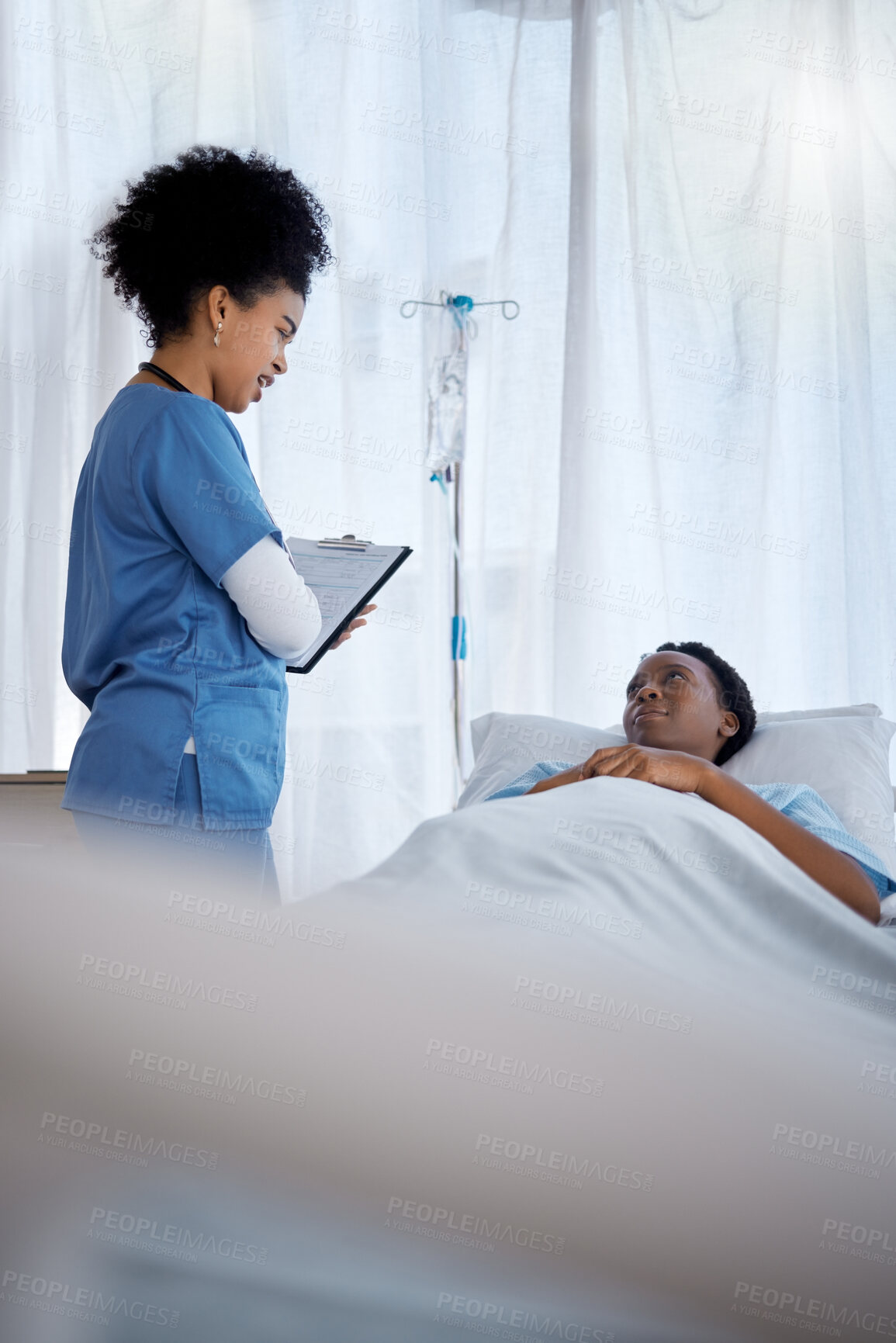 Buy stock photo Consultation, black woman in hospital bed and nurse with clipboard for symptoms, questions or results. Health, wellness and sick patient consulting medical worker with checklist for help or recovery