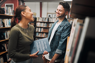 Buy stock photo Man, woman and talking in library, knowledge and bonding with smile. Young female, male and students in bookstore, education and book for learning, studying or conversation for literature and novels.