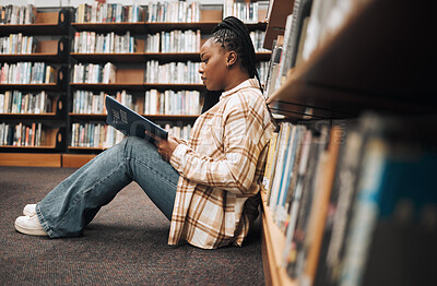 Buy stock photo Library, college student and black woman reading books on ground floor for education, studying and campus learning. University student, girl and bookshelf for project, knowledge and academy research