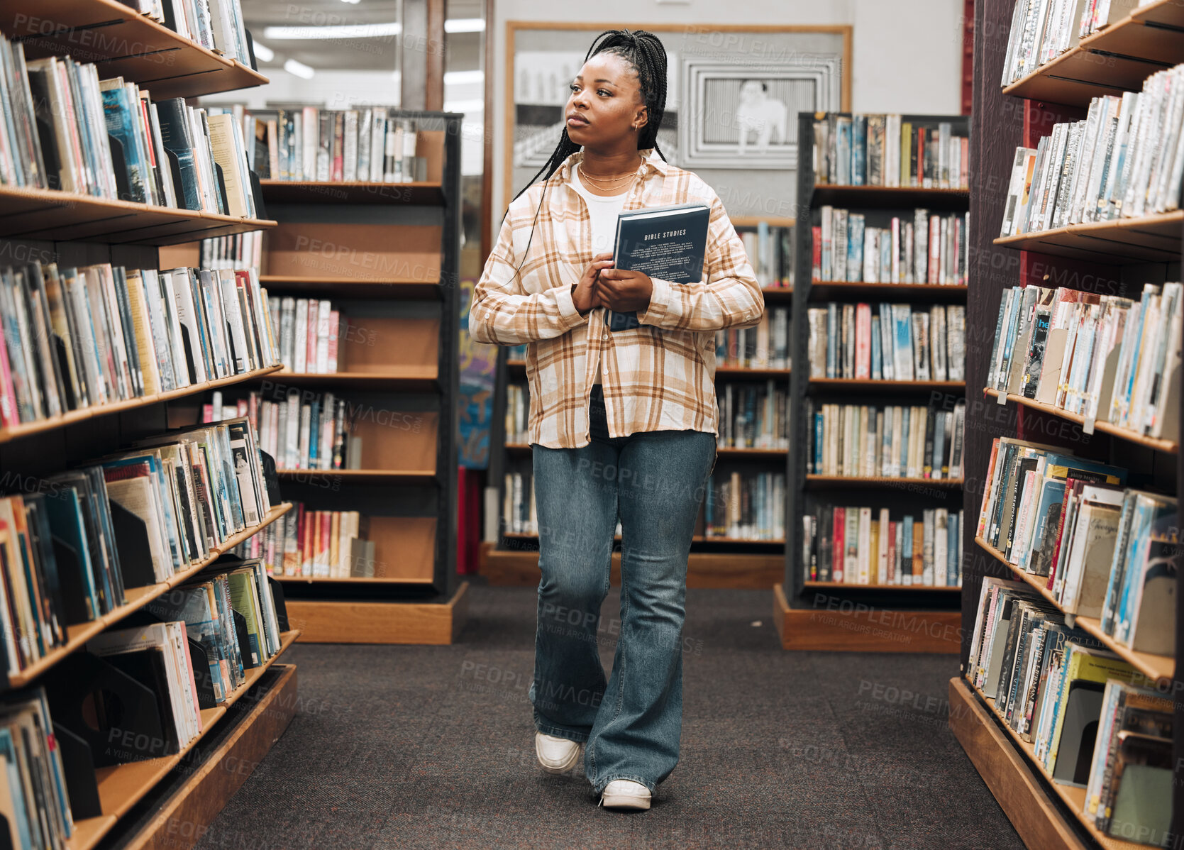 Buy stock photo Search, university or black woman in a library for books, educational knowledge or research on a college campus. Scholarship, future or African school student walking or shopping in retail book store