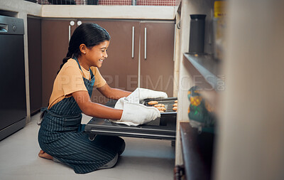 Buy stock photo Child, nutrition and cookies tray in oven kitchen for baking,  child development and learning cooking skills and happy in family home. Hungry little girl, smile and bake recipe for eating in house