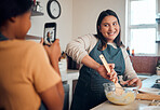 Baking, tutorial and social media with a chef woman in the kitchen of her home cooking as an influencer. Food, phone and vlog with a female cook preparing baked goods while live streaming in a house