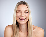 Beauty, skincare and face of happy aesthetic woman with a smile for hair care, cosmetics and makeup on a gray studio background with a glow. Portrait of a female showing dermatology results on skin