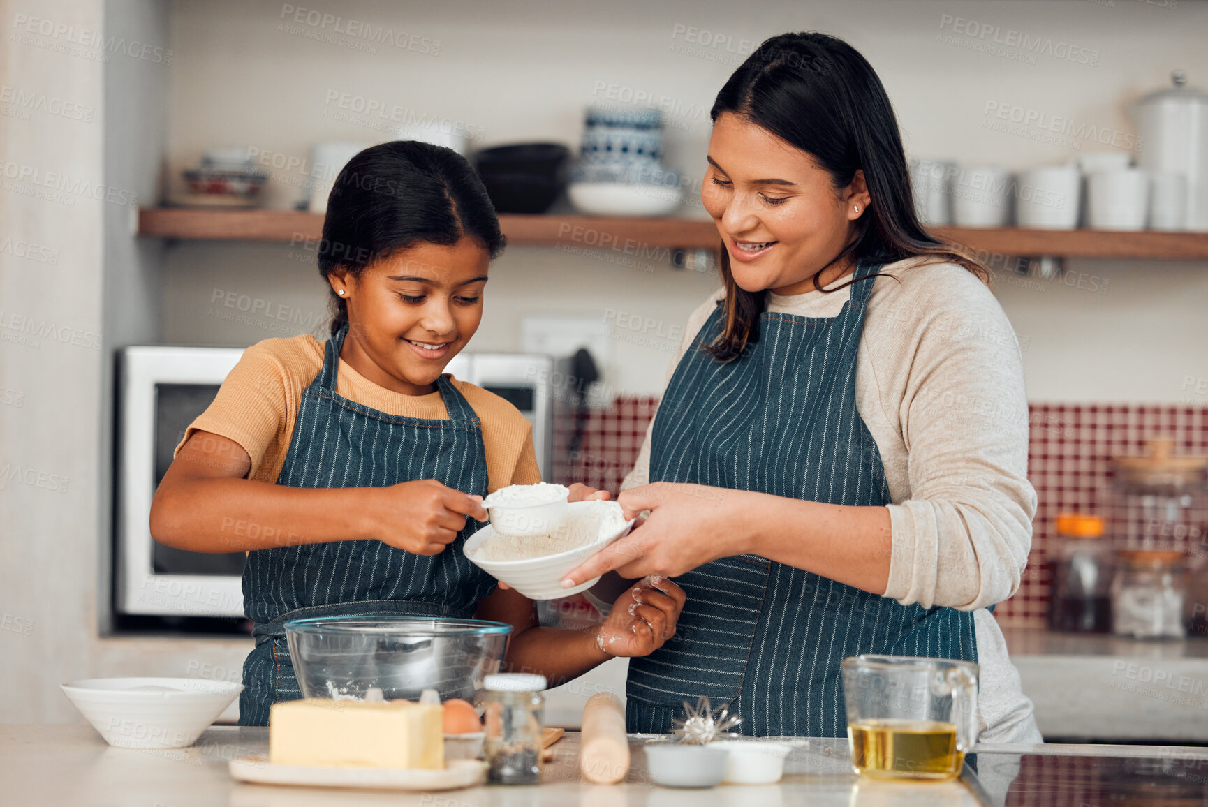 Buy stock photo Learning, family and cooking cake with mother for bonding, wellness and help with smile. Happy family, kitchen and mom teaching young daughter baking skill with flour measurement in home.