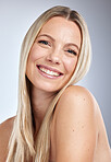 Face portrait, skincare and makeup of woman in studio isolated on a gray background. Natural beauty, aesthetics and cosmetics of female model with long blonde hair after salon treatment for growth.