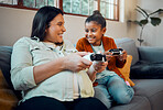Mother, child and video game in home to relax together for happy family bonding on weekend. Wellness, happy and pregnant mom playing joystick game with kid on sofa for fun moment in house.

