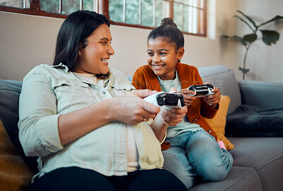 Buy stock photo Mother, child and video game in home to relax together for happy family bonding on weekend. Wellness, happy and pregnant mom playing joystick game with kid on sofa for fun moment in house.

