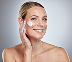 Beauty, face and cream for skincare, woman with moisturizer and natural cosmetics product, facial portrait against studio background. Cosmetic, lotion and healthy skin for wellness and dermatology.