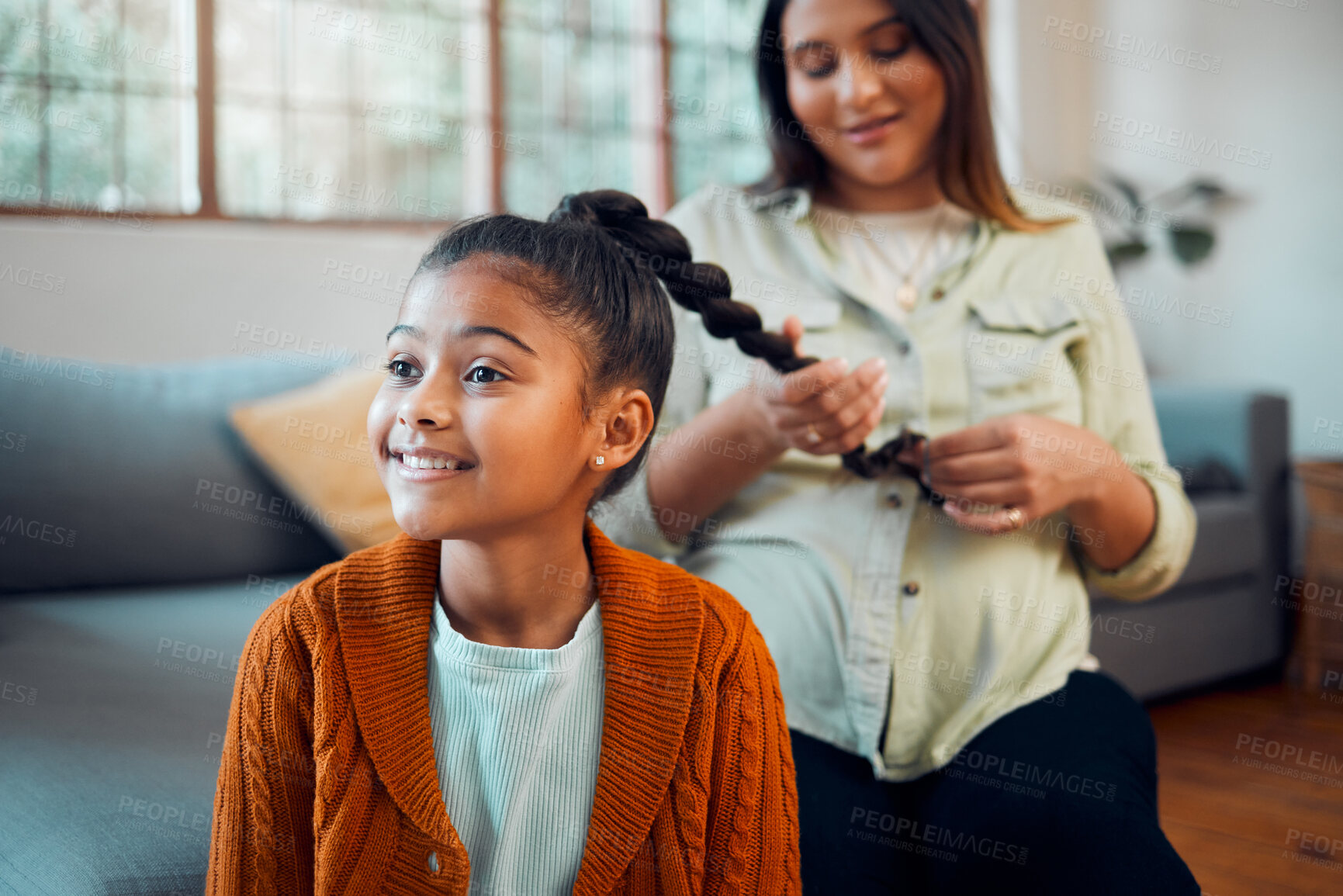 Buy stock photo Mom, girl and hair care in living room for bonding, love and care by sofa with happiness in home. Hair, mother and daughter for hairdresser, pony tail or helping hand with grooming for kid in Atlanta