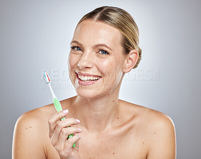 Face, teeth and woman with toothbrush in studio isolated on a gray background. Oral health, dental veneers and female model getting ready to brush with toothpaste for hygiene, cleaning and wellness.