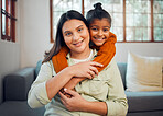 Family, portrait and mother with girl on a sofa embrace, relax and smile in their home together.  Face, mom and child hugging on a couch, enjoying bond, weekend and quality time in a living room