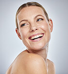 Face, beauty skincare and woman in studio isolated on a gray background. Thinking, cosmetics and happy female model in makeup smiling after spa facial treatment for healthy, glowing and flawless skin