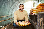 Portrait, chicken farmer and man with eggs at farm in barn or chicken coop. Agro sustainability, food agriculture and happy male small business owner holding organic poultry products, egg and protein