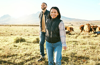 Buy stock photo Farm, agriculture and cattle with a couple walking on a field or meadow together for beef of dairy farming. Cow, sustainability and teamwork with a man and woman farmer bonding while working outdoor