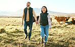 Couple, holding hands and farm in countryside travel, trip or adventure with live cattle together in nature. Happy man and woman smiling for relationship, traveling or freedom in natural agriculture