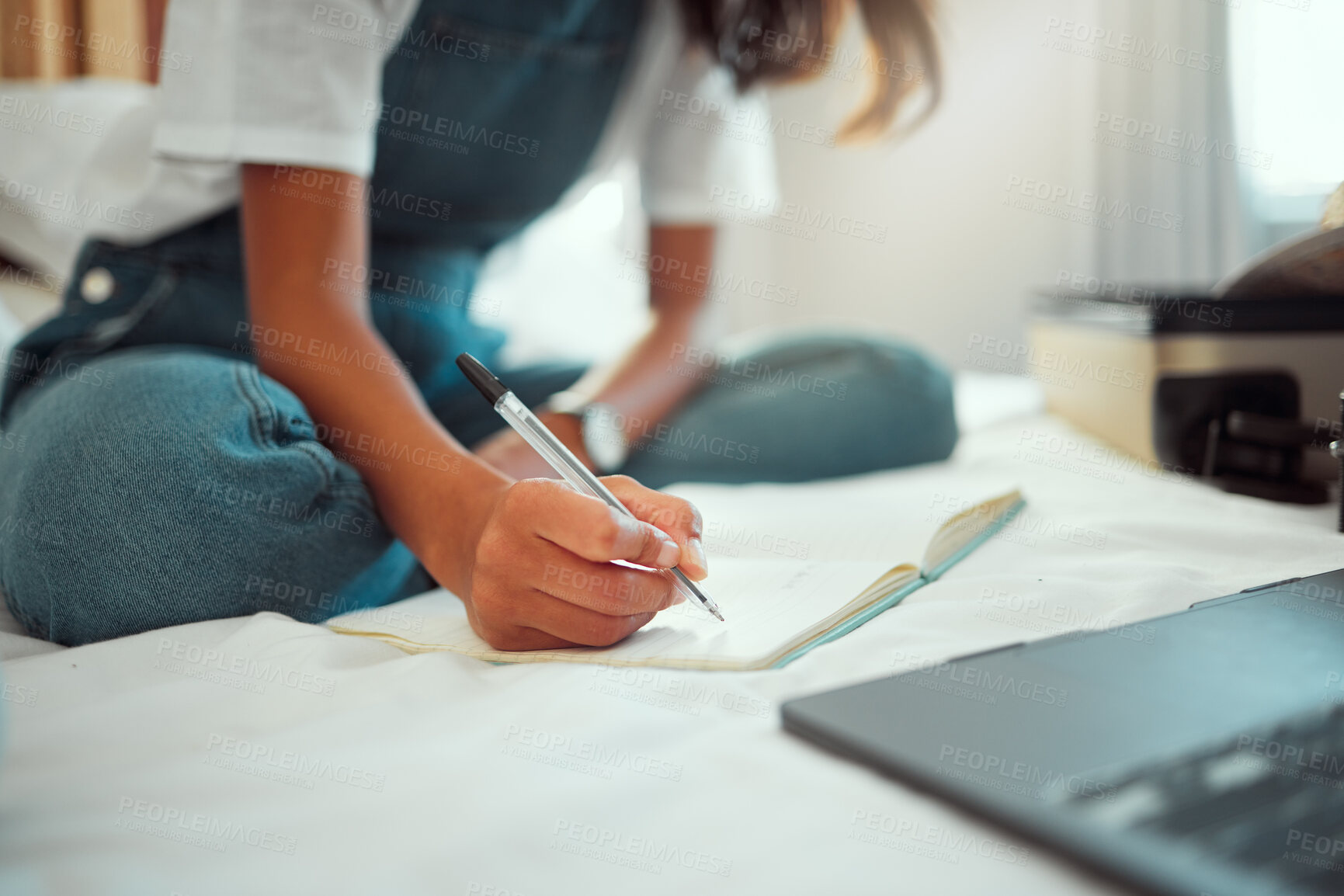 Buy stock photo Hand, writing and notebook with a woman on a bed in her home while blogging, studying or doing research. Bedroom, relax and laptop with a female student holding a pen during a search or planning